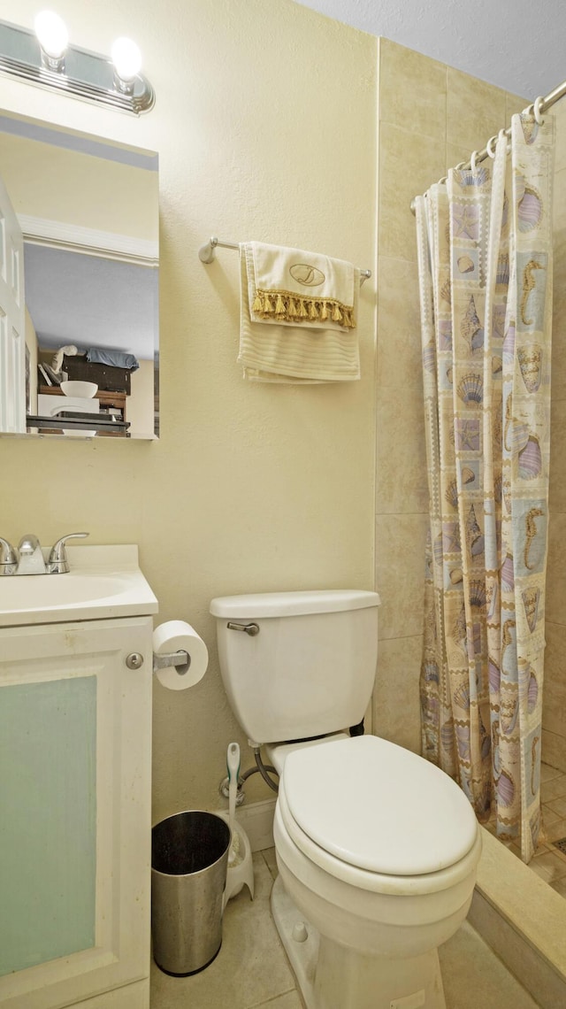 bathroom with toilet, vanity, tile patterned floors, and a shower with curtain