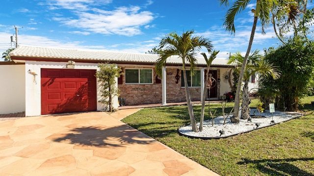 view of front of house featuring a garage and a front lawn