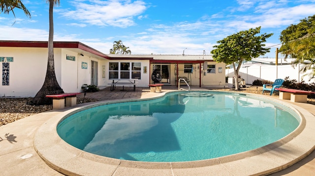 view of swimming pool featuring a patio area