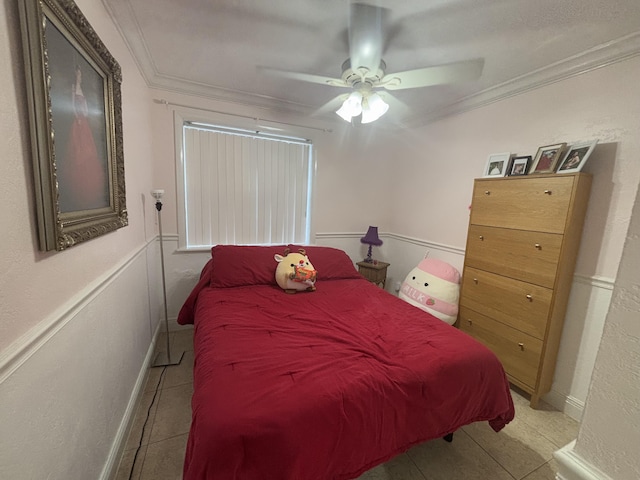 bedroom featuring crown molding, light tile patterned floors, and ceiling fan