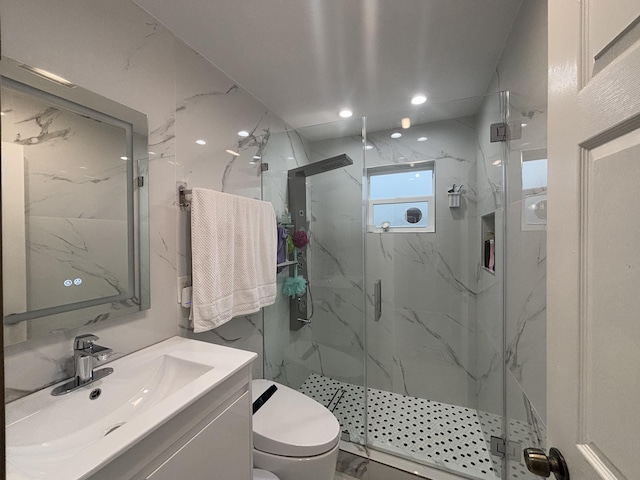 bathroom with toilet, walk in shower, and vanity