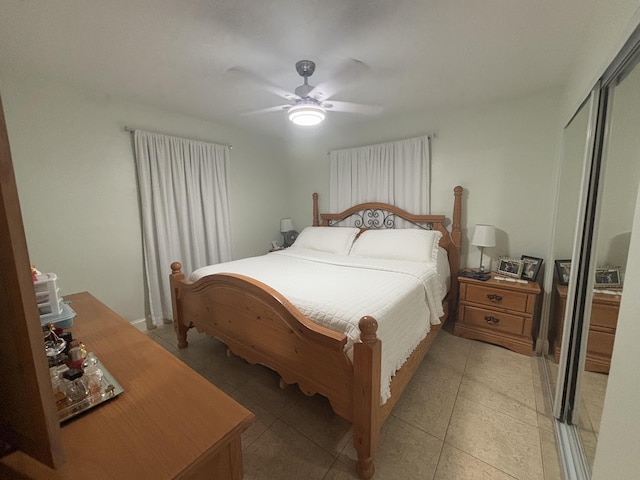 tiled bedroom featuring a closet and ceiling fan