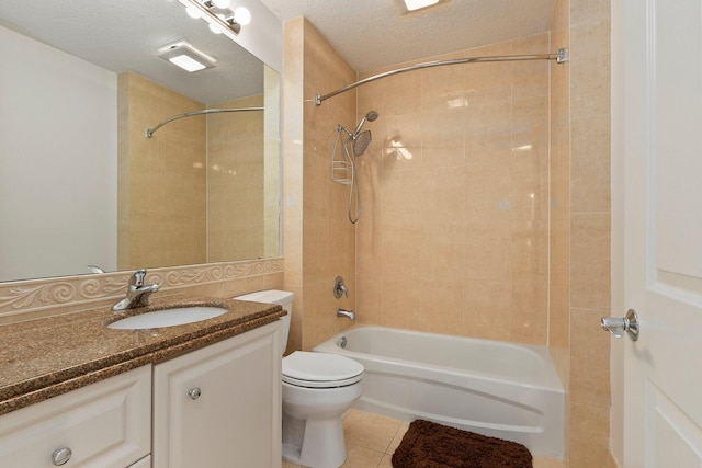 full bathroom featuring vanity, a textured ceiling, tiled shower / bath, tile patterned floors, and toilet