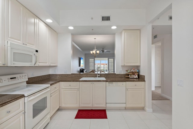 kitchen featuring white cabinetry, sink, white appliances, and a chandelier