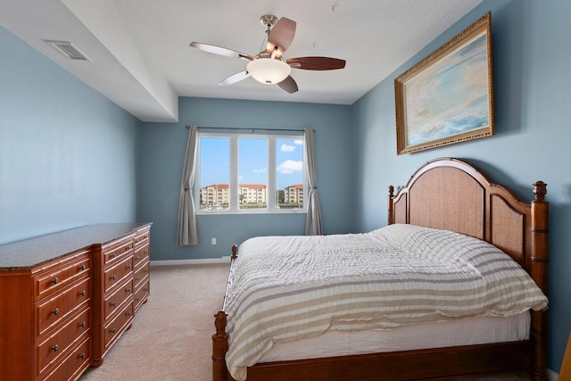 bedroom featuring light colored carpet and ceiling fan