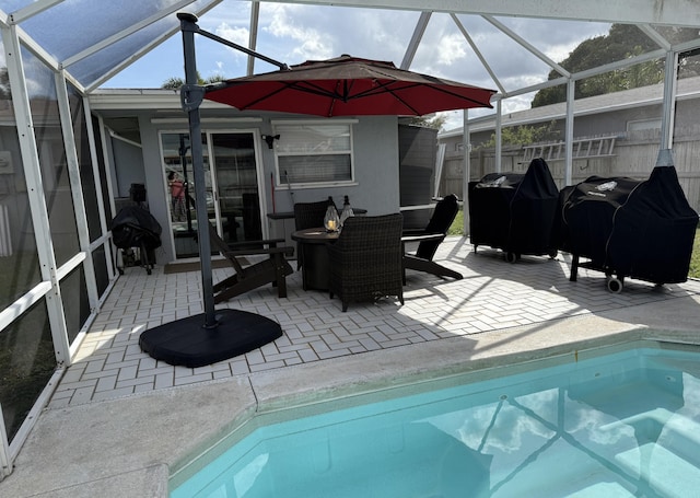 view of pool with a fenced in pool, grilling area, a lanai, fence, and a patio area