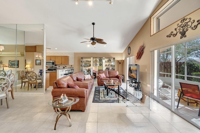 tiled living room featuring vaulted ceiling and ceiling fan