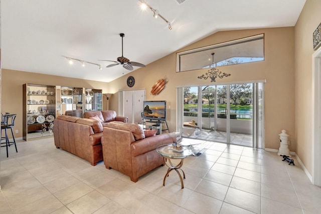 living room featuring light tile patterned floors, vaulted ceiling, ceiling fan, and track lighting