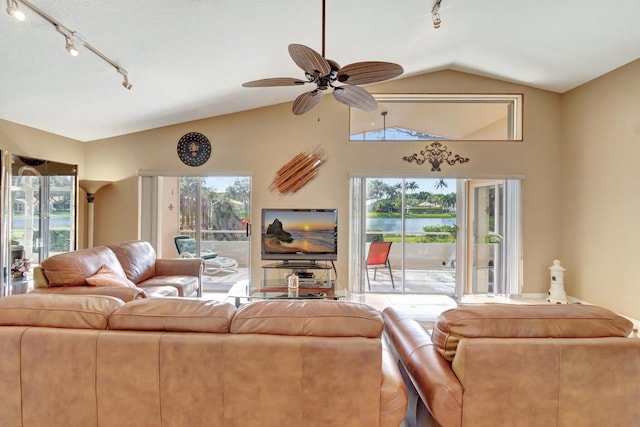 living room featuring ceiling fan, lofted ceiling, and a wealth of natural light