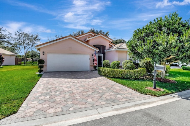 view of front of property featuring a garage and a front lawn