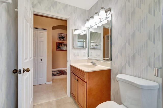 bathroom with tile patterned flooring, vanity, and toilet