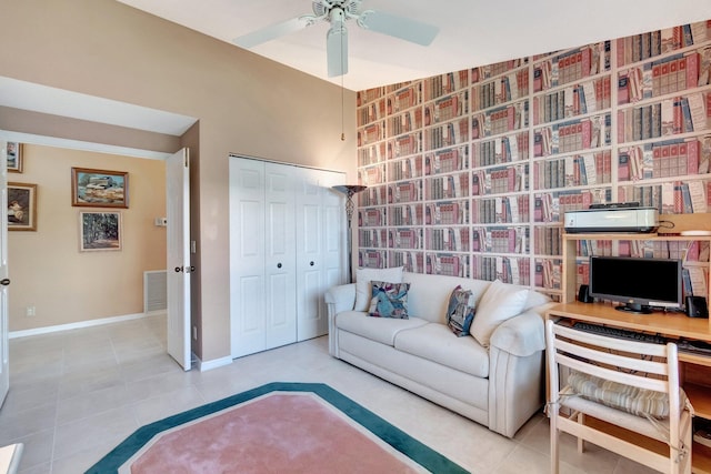 living room with ceiling fan and light tile patterned flooring