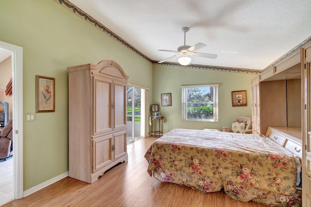 bedroom with lofted ceiling, light wood-type flooring, access to outside, ceiling fan, and a textured ceiling