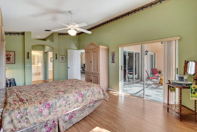 bedroom with ceiling fan, ensuite bathroom, access to exterior, and light wood-type flooring