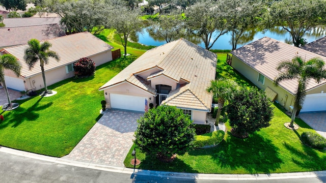 birds eye view of property with a water view