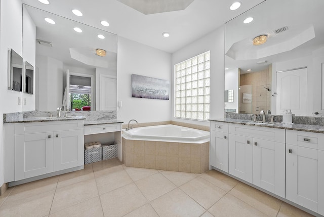 bathroom featuring independent shower and bath, a healthy amount of sunlight, and tile patterned floors