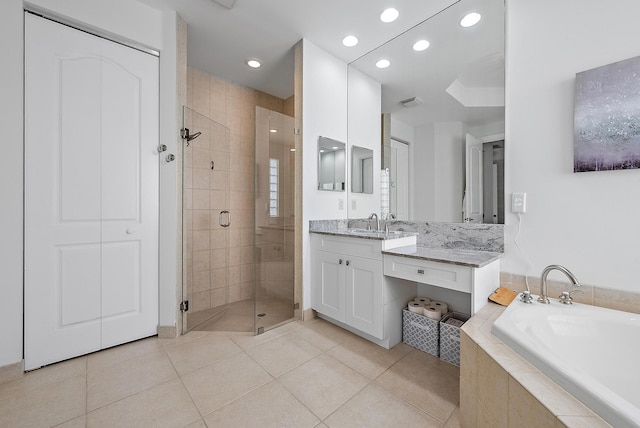 bathroom featuring tile patterned floors, vanity, and shower with separate bathtub