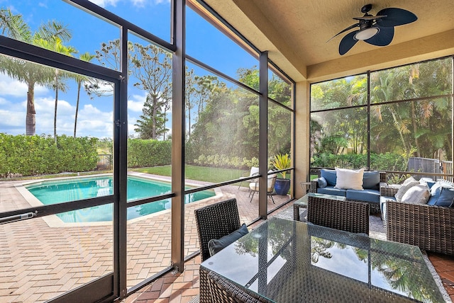 unfurnished sunroom featuring ceiling fan