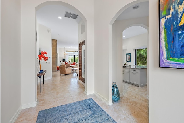 hall featuring light tile patterned floors