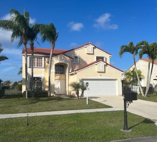 mediterranean / spanish-style house with a front yard