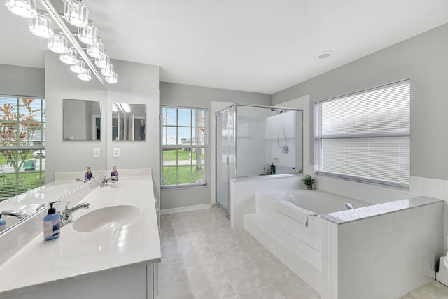 bathroom with tile patterned floors, vanity, a chandelier, and shower with separate bathtub