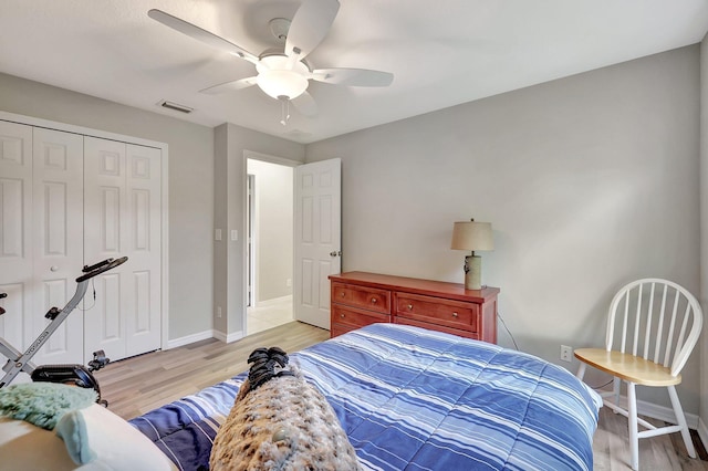 bedroom featuring light hardwood / wood-style floors, a closet, and ceiling fan