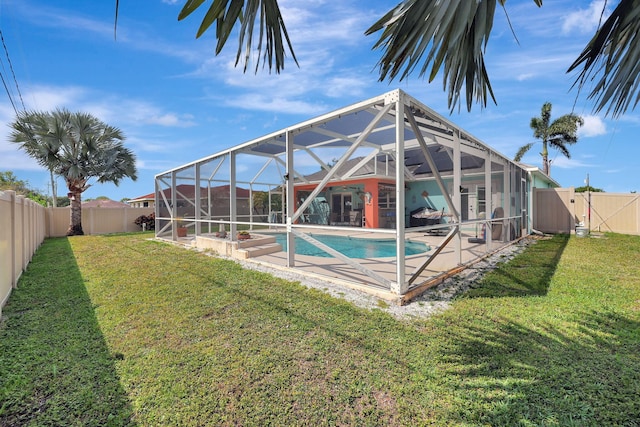 view of swimming pool with a patio area, a lanai, and a lawn