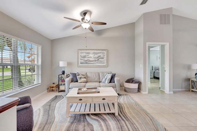 living room featuring vaulted ceiling, ceiling fan, and light tile patterned floors