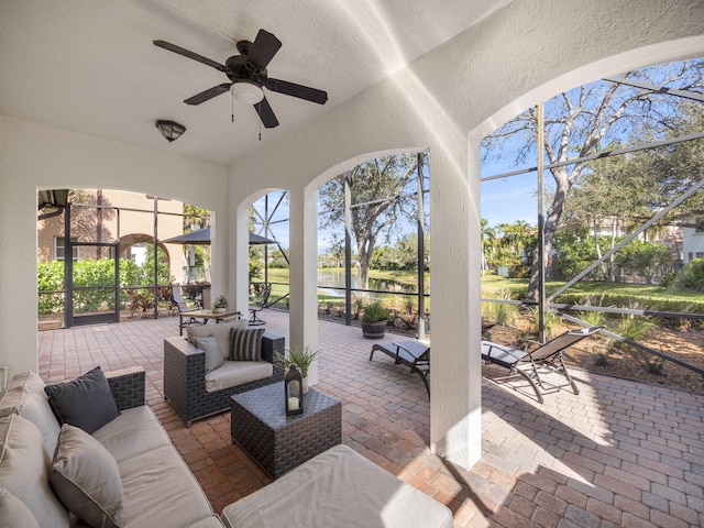 view of patio / terrace with a lanai, an outdoor hangout area, and ceiling fan