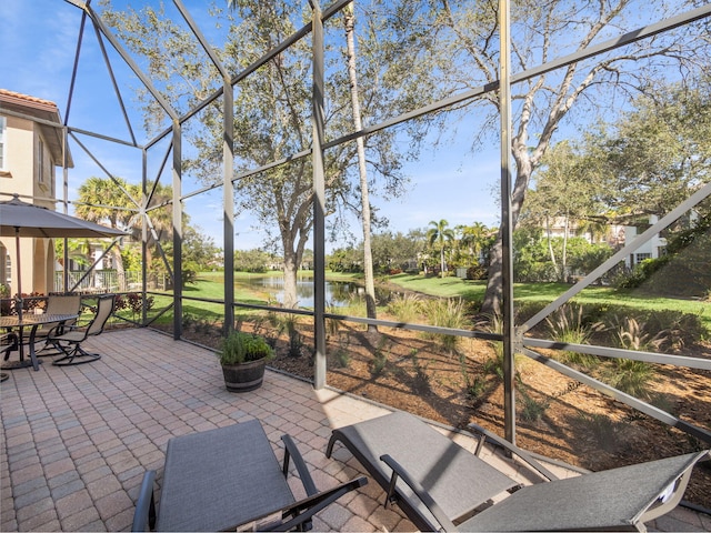 unfurnished sunroom featuring a water view