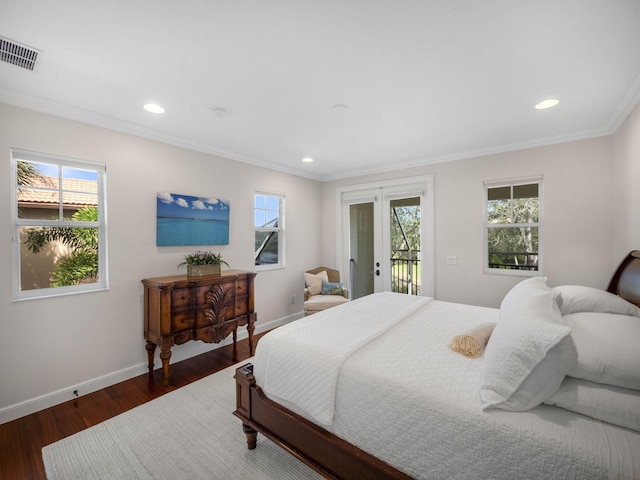 bedroom featuring dark hardwood / wood-style floors, ornamental molding, and access to exterior