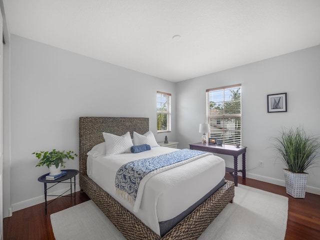 bedroom with dark hardwood / wood-style flooring