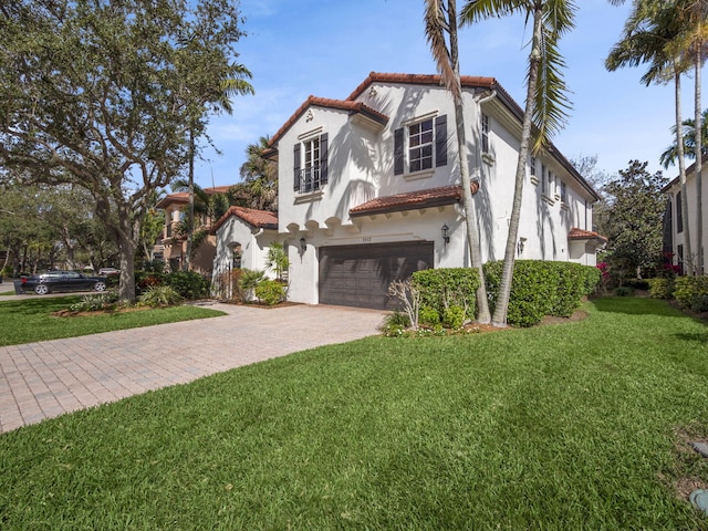 mediterranean / spanish-style house featuring a garage and a front lawn