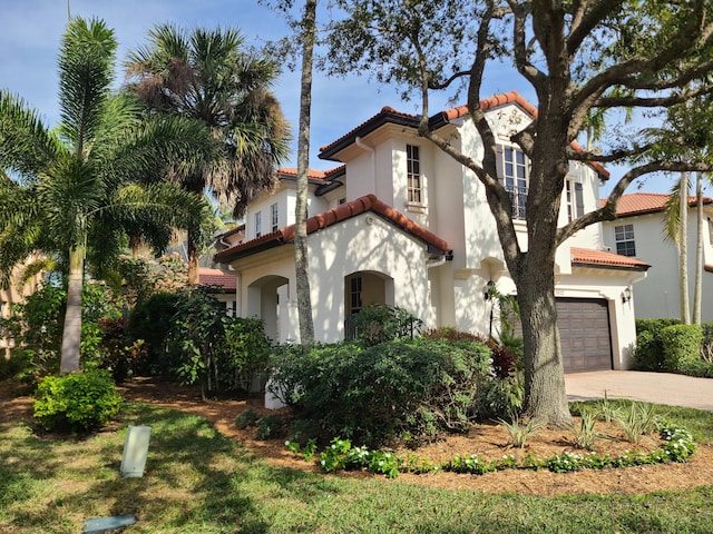 mediterranean / spanish house with a garage