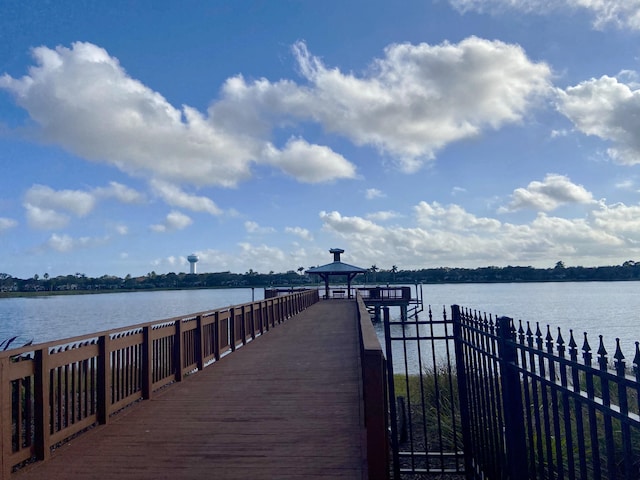 view of dock with a gazebo and a water view