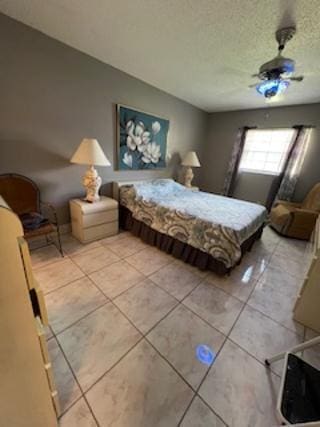 bedroom featuring a textured ceiling and light tile patterned floors