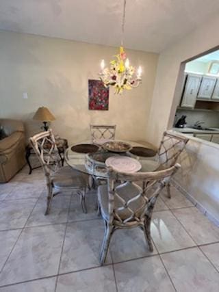 dining space with light tile patterned floors and a notable chandelier