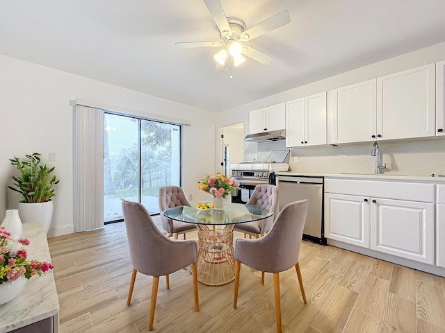 kitchen featuring appliances with stainless steel finishes, light hardwood / wood-style floors, and white cabinets