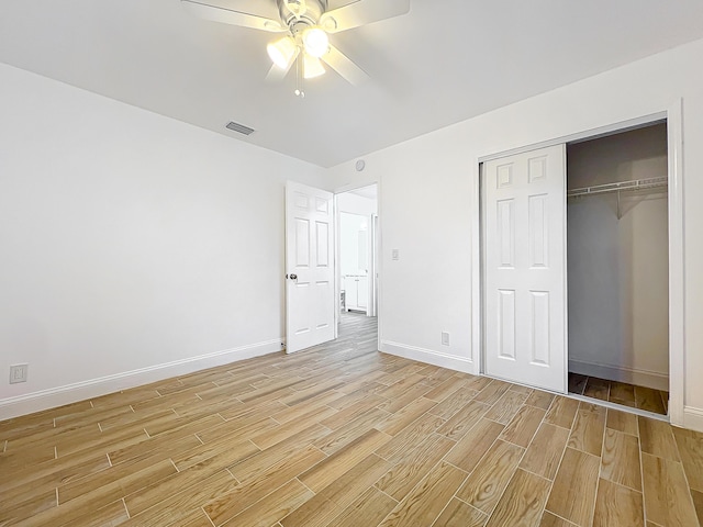 unfurnished bedroom featuring ceiling fan and a closet