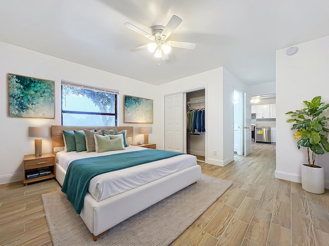 bedroom featuring ceiling fan, a closet, and light hardwood / wood-style floors