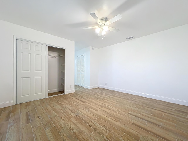 unfurnished bedroom with ceiling fan and light hardwood / wood-style floors