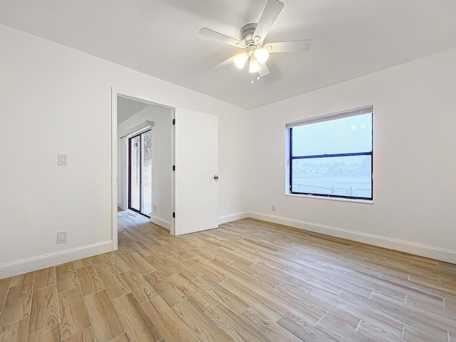 spare room featuring light hardwood / wood-style floors and ceiling fan