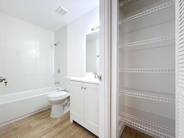 full bathroom featuring toilet, vanity, and tiled shower / bath