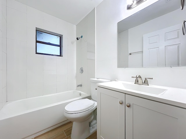 full bathroom with toilet, tiled shower / bath combo, and vanity