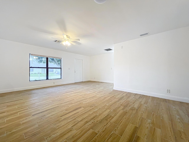 empty room featuring ceiling fan and light hardwood / wood-style flooring