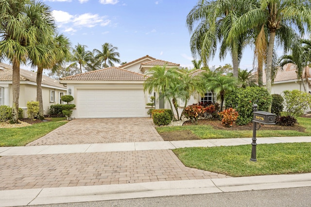 mediterranean / spanish-style home with a garage