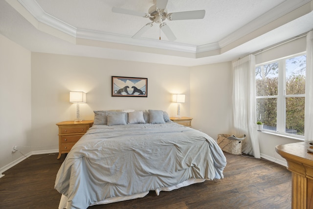 bedroom with ceiling fan, a raised ceiling, and multiple windows