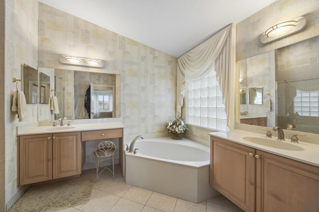 bathroom with a bath, tile patterned floors, and vanity