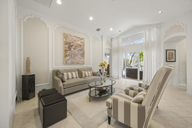 living room with lofted ceiling and light tile patterned floors