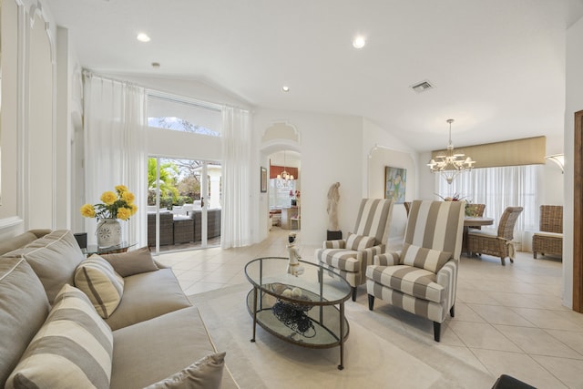 living room with vaulted ceiling, an inviting chandelier, and light tile patterned floors